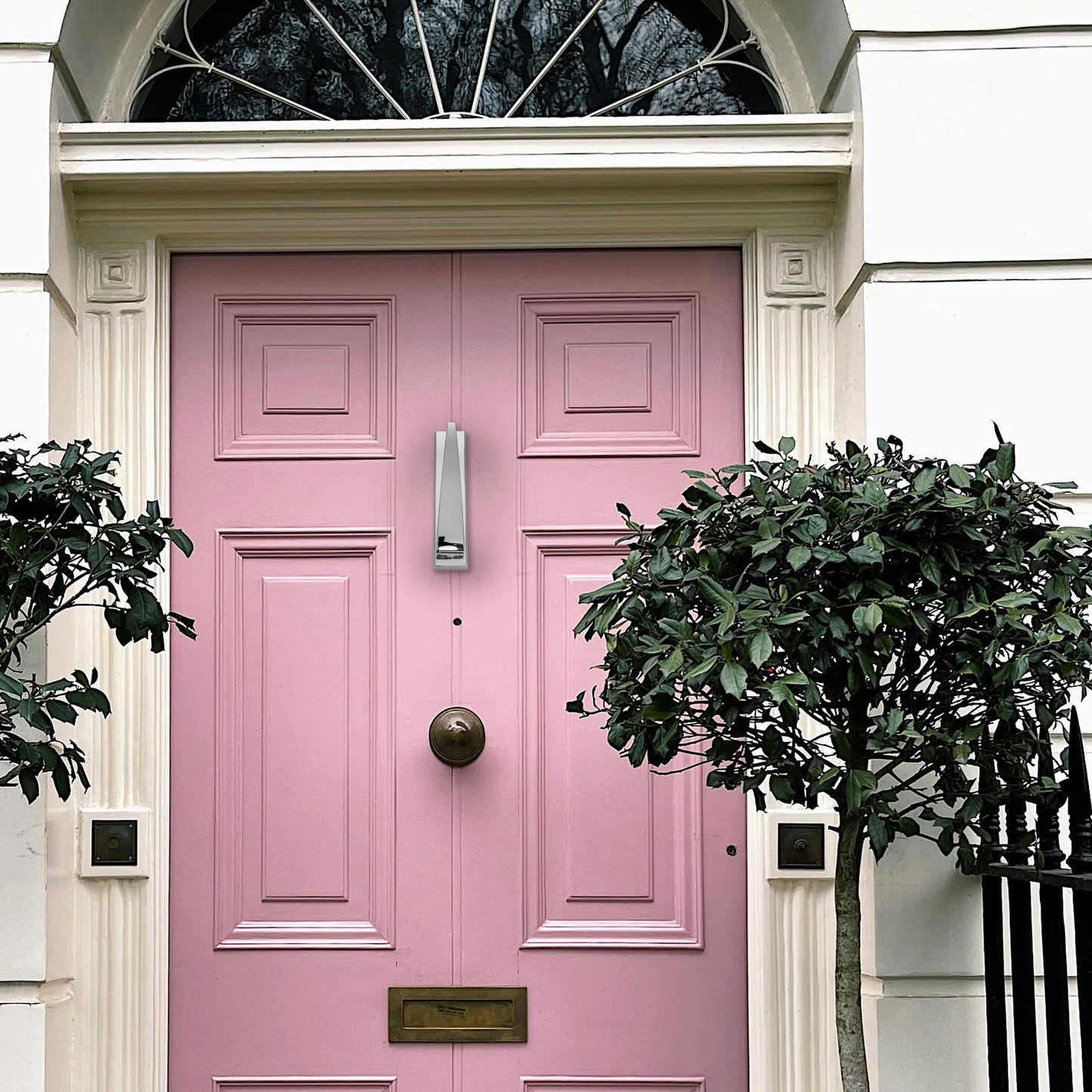 SIZAH Ponytail Door Knocker on Pink Door - Showcasing how the sleek, modern knocker enhances your entryway with its elegant design, perfect for adding a stylish touch to any door.